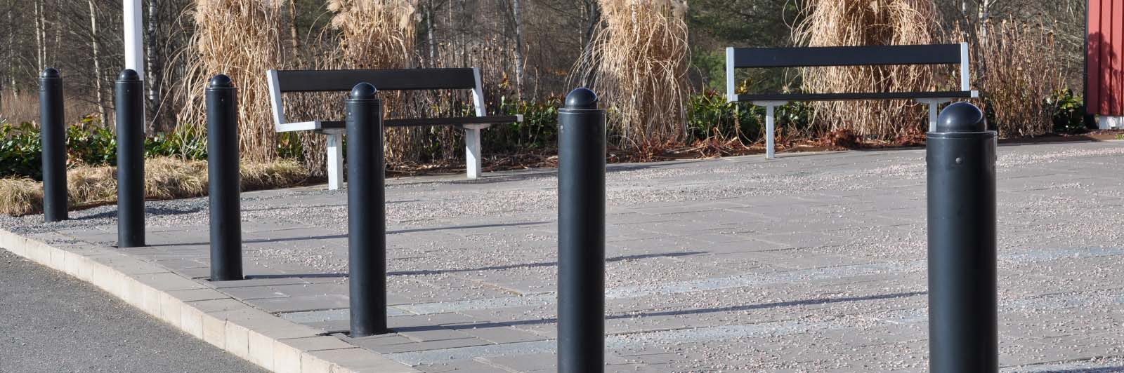 A row of parking bollards to stop cars from accessing a pedestrian street.